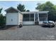 Charming home exterior featuring a screened-in porch, shed, and boats for outdoor recreation at 217 Badin View Dr # B257, New London, NC 28127