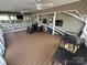 Relaxing porch setup with comfortable seating area, ceiling fans, and TV at 217 Badin View Dr # B257, New London, NC 28127