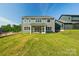 Expansive backyard view of two-story home with ample green space at 220 Windy Dell Dr, Tega Cay, SC 29708