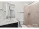 This bathroom features a tile shower, white vanity top, and large mirror with great lighting at 220 Windy Dell Dr, Tega Cay, SC 29708