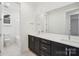 Bathroom showcasing a vanity with dual sinks, cabinets, and a separate tub/shower at 220 Windy Dell Dr, Tega Cay, SC 29708