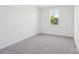 Neutral carpeted bedroom featuring a bright window and neutral colors at 220 Windy Dell Dr, Tega Cay, SC 29708