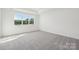 Bright bedroom featuring a large window, plush carpeting and neutral color scheme at 220 Windy Dell Dr, Tega Cay, SC 29708