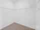 Walk-in closet providing ample storage with wire shelving and neutral carpeting at 220 Windy Dell Dr, Tega Cay, SC 29708