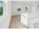 The upstairs hallway boasts wood-look floors, crisp white trim and large windows providing natural light at 220 Windy Dell Dr, Tega Cay, SC 29708