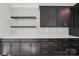 Stylish kitchen with modern backsplash, sleek countertops, and dark cabinetry at 220 Windy Dell Dr, Tega Cay, SC 29708