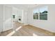 The bright living room boasts wood-look floors, a gas fireplace, and modern white trim and doors at 220 Windy Dell Dr, Tega Cay, SC 29708