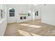 Bright living room featuring a fireplace, hardwood floors, and many windows at 220 Windy Dell Dr, Tega Cay, SC 29708