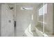 Luxurious walk-in shower featuring sleek tiling, a glass enclosure, and a comfortable bench at 220 Windy Dell Dr, Tega Cay, SC 29708