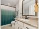 Clean bathroom featuring a vanity, sink, and shower with an ombre curtain at 2245 Lincolnshire Ln, Waxhaw, NC 28173