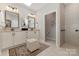Well-lit bathroom featuring a double vanity, granite countertops, and a separate toilet room and tiled shower at 2245 Lincolnshire Ln, Waxhaw, NC 28173