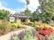 Entrance to The Courtyards featuring a pergola and lush, colorful landscaping at 2245 Lincolnshire Ln, Waxhaw, NC 28173