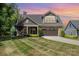 Charming two-story home featuring a well-manicured lawn, stone accents, and an attached two-car garage at 2245 Lincolnshire Ln, Waxhaw, NC 28173