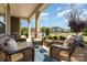 Inviting front porch with comfortable wicker furniture and a view of the neighborhood at 2245 Lincolnshire Ln, Waxhaw, NC 28173