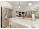 Open kitchen with stainless steel refrigerator, white cabinets, and a farmhouse sink overlooking the living area at 2245 Lincolnshire Ln, Waxhaw, NC 28173