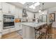Bright kitchen showcasing stainless steel appliances, a center island with seating, and ample cabinet space at 2245 Lincolnshire Ln, Waxhaw, NC 28173