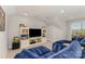 Comfortable living room with built-in shelving and a large television at 2245 Lincolnshire Ln, Waxhaw, NC 28173