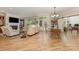 Open-concept living room with hardwood floors, a fireplace, and dining area, perfect for entertaining at 2245 Lincolnshire Ln, Waxhaw, NC 28173