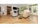 Spacious living room boasts hardwood floors, a fireplace, and large windows for ample natural light at 2245 Lincolnshire Ln, Waxhaw, NC 28173