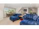 Open living room featuring blue couches, a dining table, and natural light at 2245 Lincolnshire Ln, Waxhaw, NC 28173