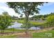 Scenic pond with a fountain surrounded by lush landscaping at 2245 Lincolnshire Ln, Waxhaw, NC 28173
