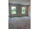 Bright bedroom features neutral carpet, two windows providing natural light, and a calming atmosphere at 242 North Ave, Troutman, NC 28166