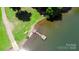 Aerial view of the lake featuring a wooden dock and green lawn at 252 Chuckwood Rd, Mooresville, NC 28117