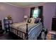 A cozy bedroom featuring a comfortable bed, warm lighting, and classic decor at 252 Chuckwood Rd, Mooresville, NC 28117
