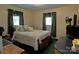 A cozy bedroom featuring a comfortable bed, warm lighting, and classic decor at 252 Chuckwood Rd, Mooresville, NC 28117