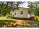 A house exterior featuring well maintained lawn and a small back deck at 252 Chuckwood Rd, Mooresville, NC 28117