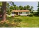 Charming single-story home featuring a well-maintained lawn and mature trees at 252 Chuckwood Rd, Mooresville, NC 28117