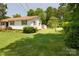 Charming home with a well-manicured lawn and mature trees enhancing curb appeal at 252 Chuckwood Rd, Mooresville, NC 28117