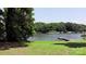 Scenic lake view highlighting lush shoreline foliage with a pier for relaxing outdoors at 252 Chuckwood Rd, Mooresville, NC 28117