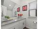 Charming bathroom featuring a gray granite countertop and sleek fixtures, illuminated by natural light from a window at 2813 Ava Ave, Charlotte, NC 28208