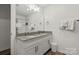 Bright bathroom featuring dual sinks with granite countertops, modern fixtures, and an elegant mirror, for a contemporary feel at 2813 Ava Ave, Charlotte, NC 28208