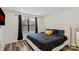 Bright bedroom features wood-look flooring, recessed lighting and a large window at 2813 Ava Ave, Charlotte, NC 28208