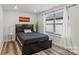 Bright bedroom features wood-look flooring, recessed lighting and a large window at 2813 Ava Ave, Charlotte, NC 28208
