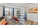 Charming dining area featuring a modern glass table, comfortable chairs, and stylish decor, adjacent to a comfortable sitting area at 2813 Ava Ave, Charlotte, NC 28208