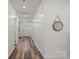 Bright hallway with wood flooring, leading to various rooms in the home at 2813 Ava Ave, Charlotte, NC 28208