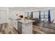 Open concept featuring a kitchen island and dishwasher overlooking a living and dining area, perfect for modern living at 2813 Ava Ave, Charlotte, NC 28208