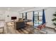 Open-concept living area showcasing a glass table with orange chairs, a sitting area, and natural light, perfect for modern living at 2813 Ava Ave, Charlotte, NC 28208