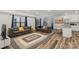Expansive living room showcases an area rug, comfortable couches, and an open layout, with a kitchen island in the background at 2813 Ava Ave, Charlotte, NC 28208