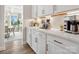 Convenient butler's pantry with white cabinets, quartz counters, and stainless steel appliances at 301 Supernova Dr, York, SC 29745