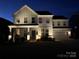 Beautiful two-story home featuring meticulous landscaping and charming curb appeal at twilight at 301 Supernova Dr, York, SC 29745