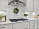 A modern kitchen featuring white cabinets, stainless steel appliances, and stylish decor at 301 Supernova Dr, York, SC 29745