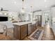 Open kitchen design with island, stainless appliances, decorative lighting, and hardwood floors at 301 Supernova Dr, York, SC 29745