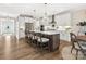 Spacious eat-in kitchen with a large island, white cabinets, stainless appliances, and modern lighting at 301 Supernova Dr, York, SC 29745
