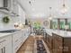 A spacious kitchen with white cabinets, wooden floors, and stylish lighting at 301 Supernova Dr, York, SC 29745