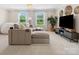 A stylish living room with neutral tones, large windows, and comfortable seating at 301 Supernova Dr, York, SC 29745