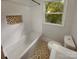 Stylish bathroom features updated fixtures, tiled walls, and pattern floor at 3109 Morson St, Charlotte, NC 28208